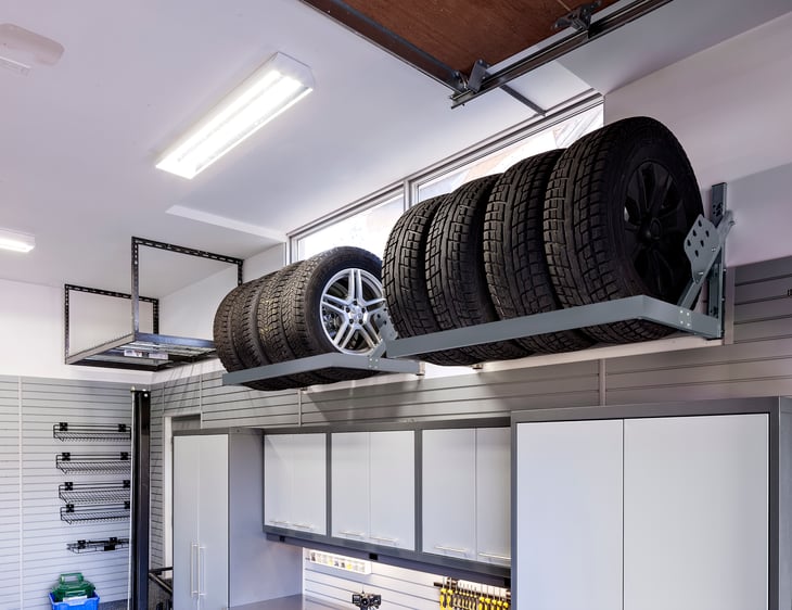 Overhead storage racks are shown holding car tires.