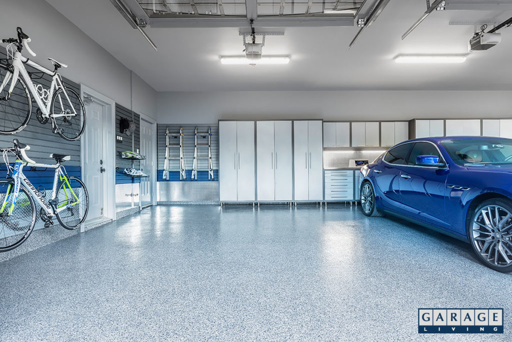 Blue-car-in-garage-with-bikes-and-cabinets-1024x683