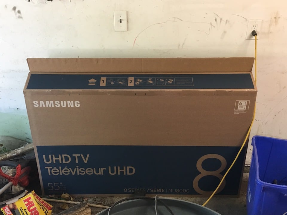 garage junk cleaning cardboard TV box