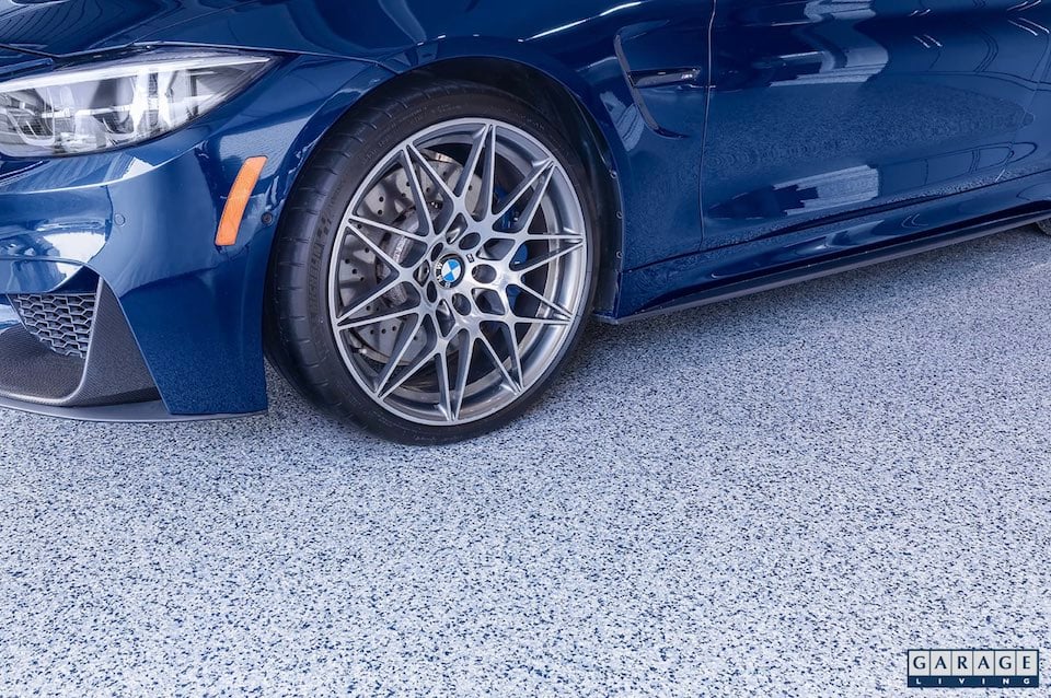 closeup of blue car on garage floor