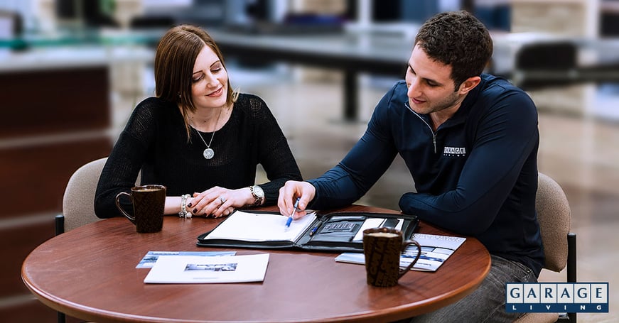 Man and woman sitting at brown table garage makeover process consultation