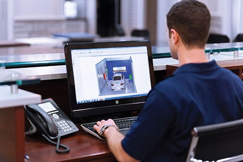 man sitting in front of computer garage makeover process design