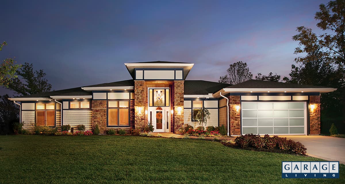 upgraded full-view aluminum garage doors on suburban home with green grass