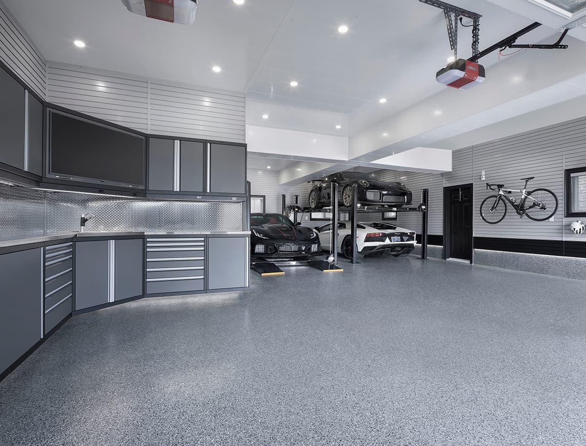 3-car garage with cabinetry and two car lifts