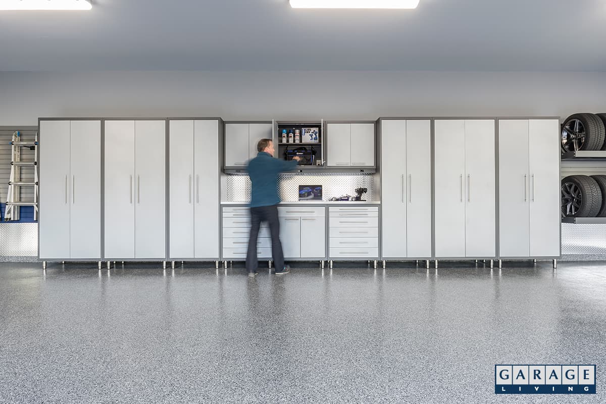 new garage floor, gray cabinets, man in blue shirt