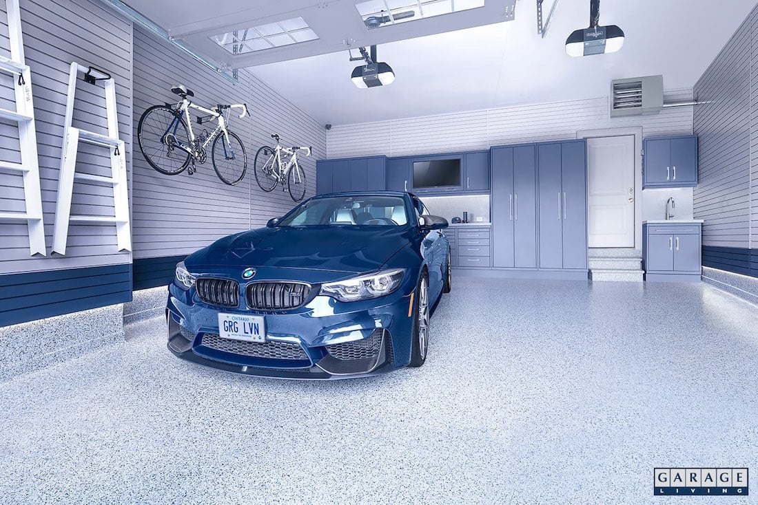 blue car in garage with hanging bikes