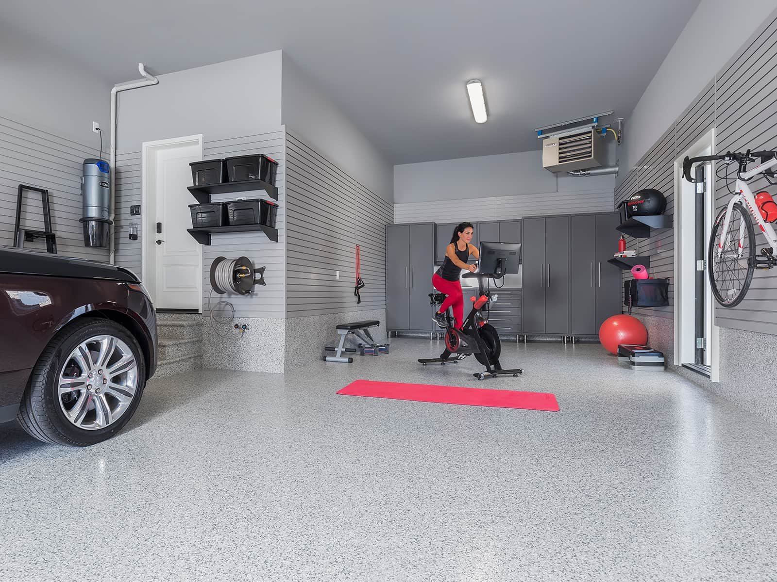 woman in garage working out on exercise bike