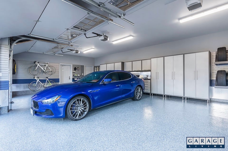 blue car surrounded by tidy garage interior