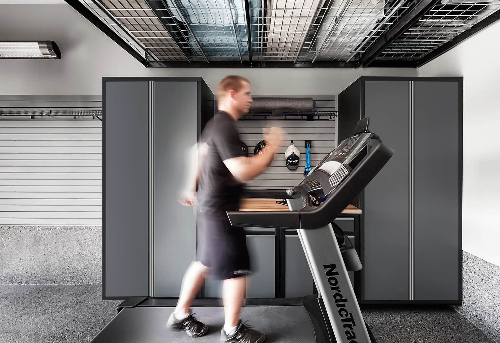 man running on treadmill in garage 