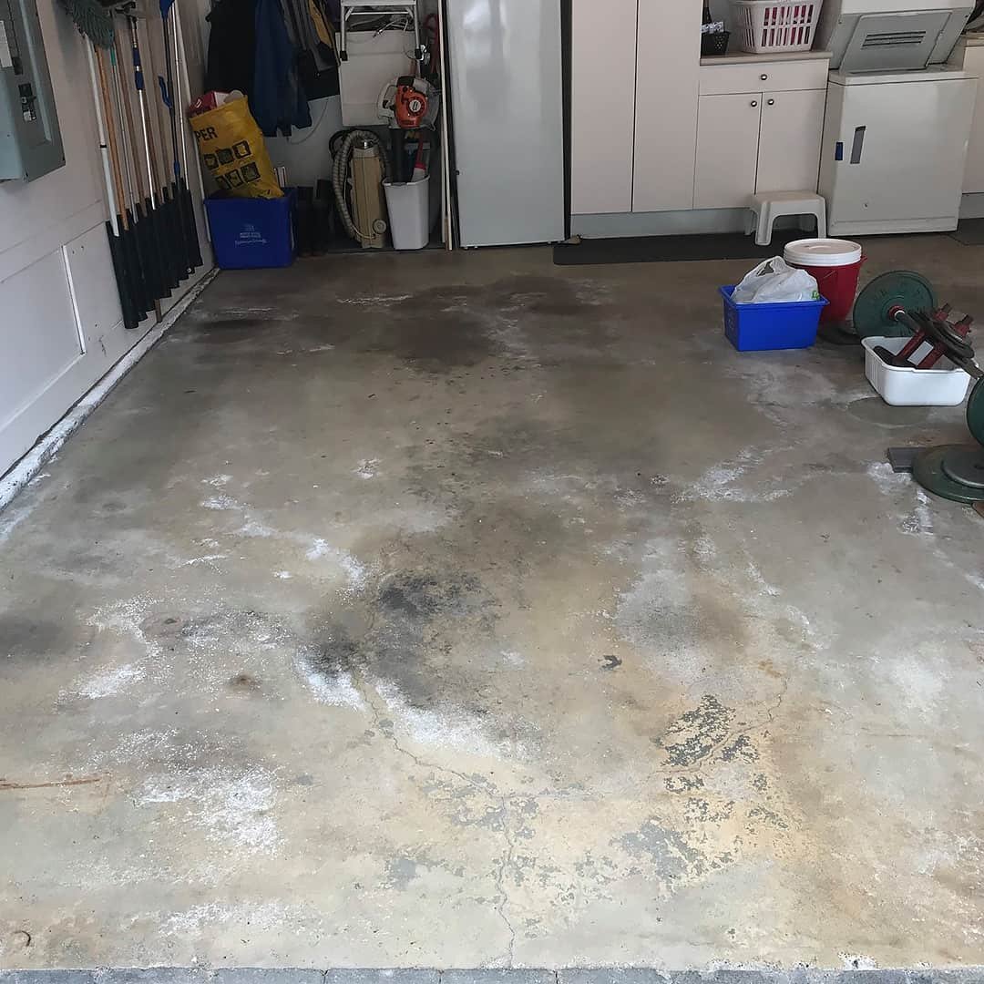 Unfinished cracked garage floor with road salt damage