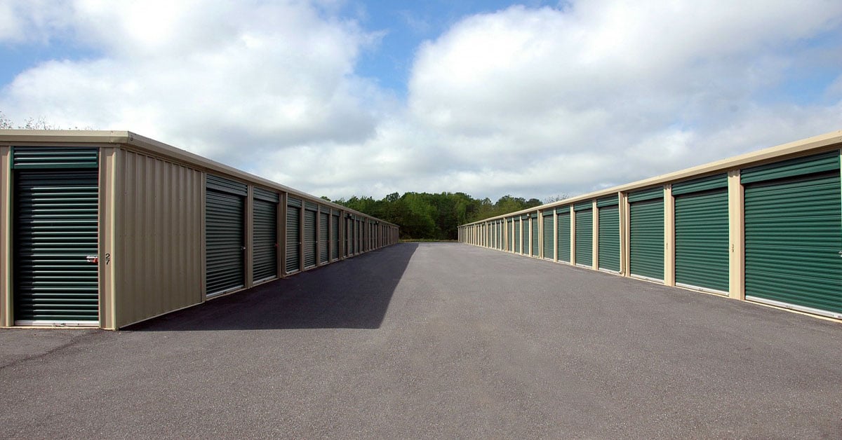 self storage units cloudy sky green doors