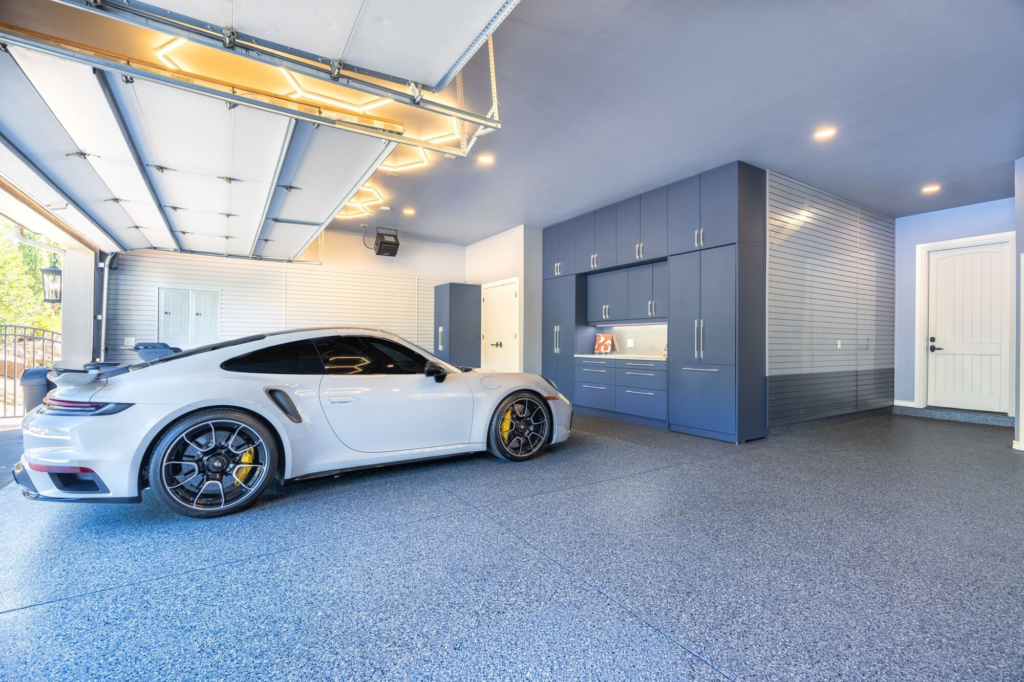 Custom lighting, hidden storage, and custom features make this garage a showcase project for Garage Living.