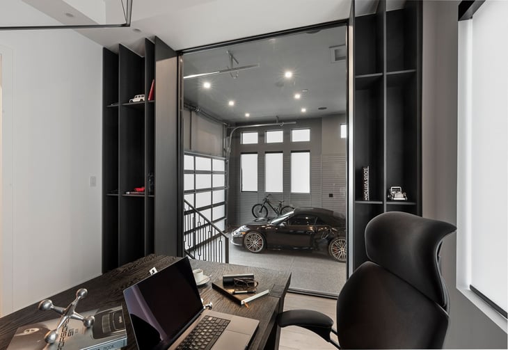 Finished garage design viewed through a floor-to-ceiling window from inside a home study