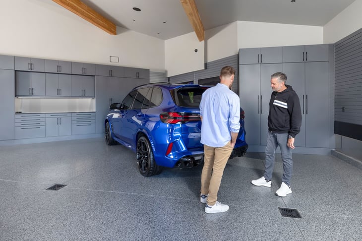 Garage Living team member discussing design details with a homeowner during a completed garage installation