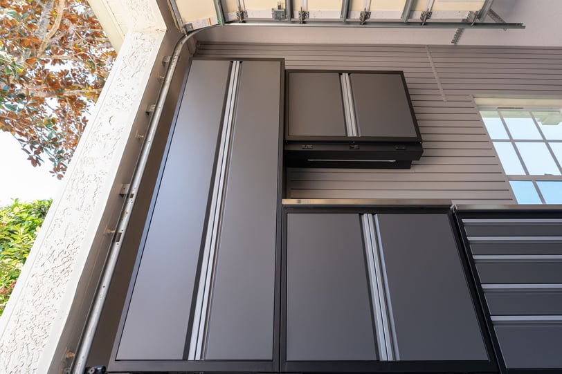Garage storage system with enclosed cabinetry and a clean, organized layout.
