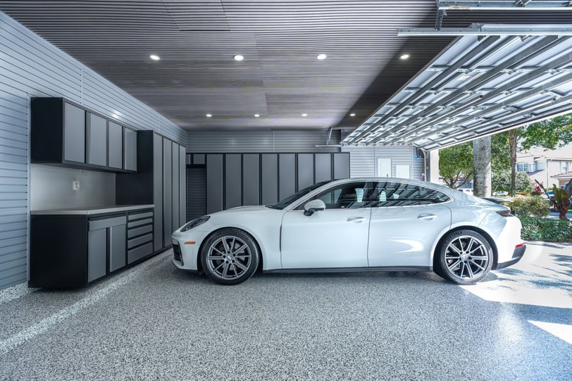 Custom garage featuring Signature cabinets, finished flooring, and organized storage.