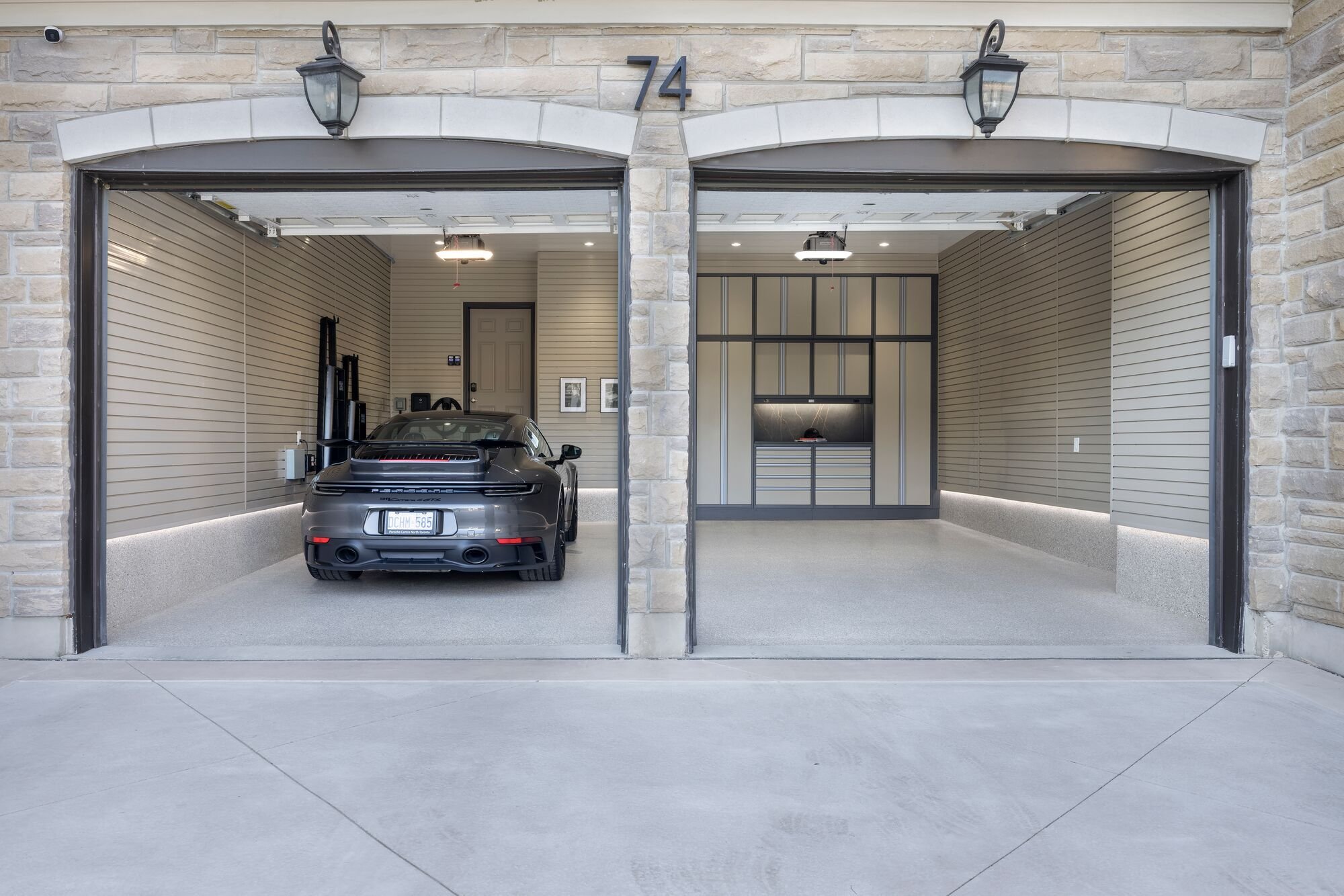 Completed garage transformation designed for parking a vehicle with premium cabinetry and flooring