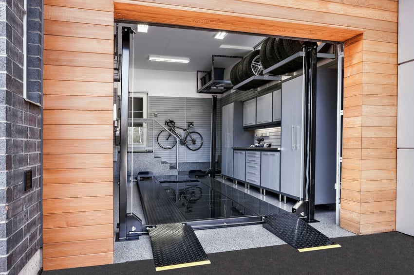 Garage car lift used to maximize vehicle storage and create more usable floor space