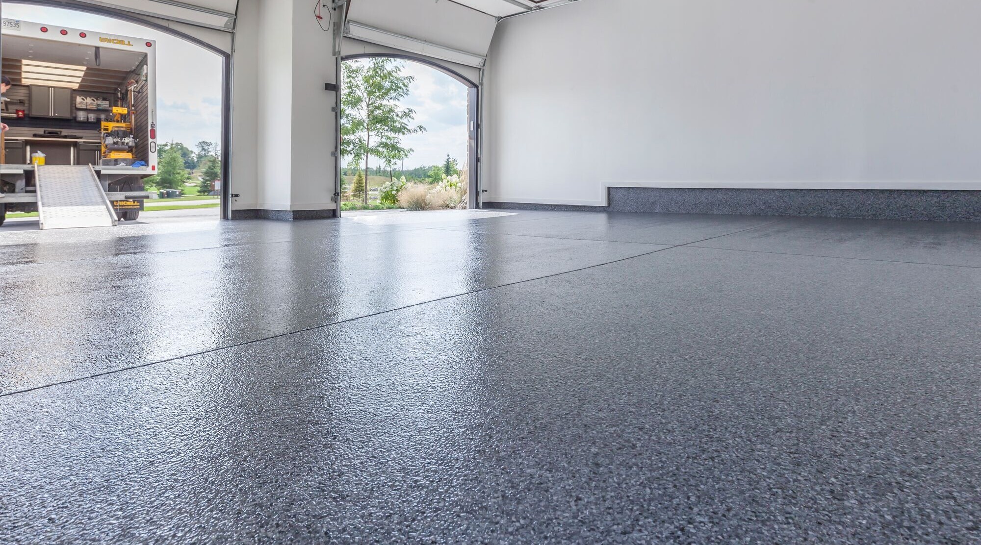 How do you evaluate the quality of a completed garage floor coating?