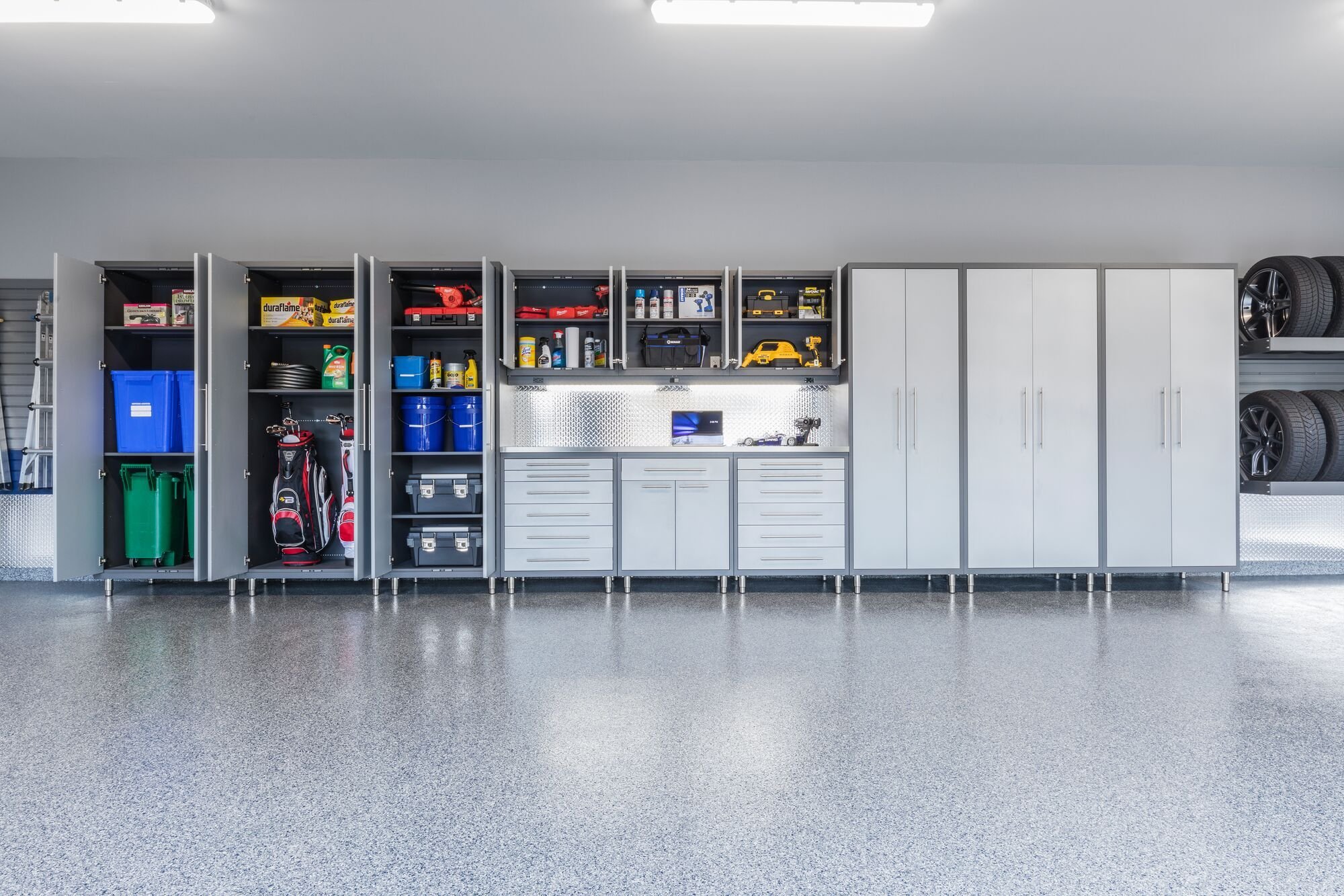 Garage entryway with custom cabinetry and wall storage for everyday home organization