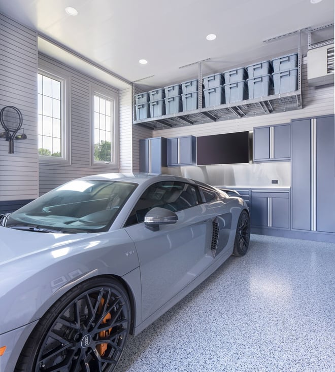 Luxury garage makeover with custom storage, garage cabinetry, and durable floor coating for vehicle storage.