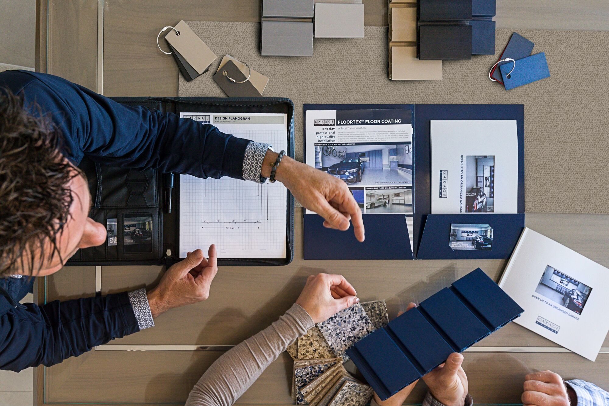 Garage Living consultant reviewing premium materials and samples with homeowners during a garage design consultation