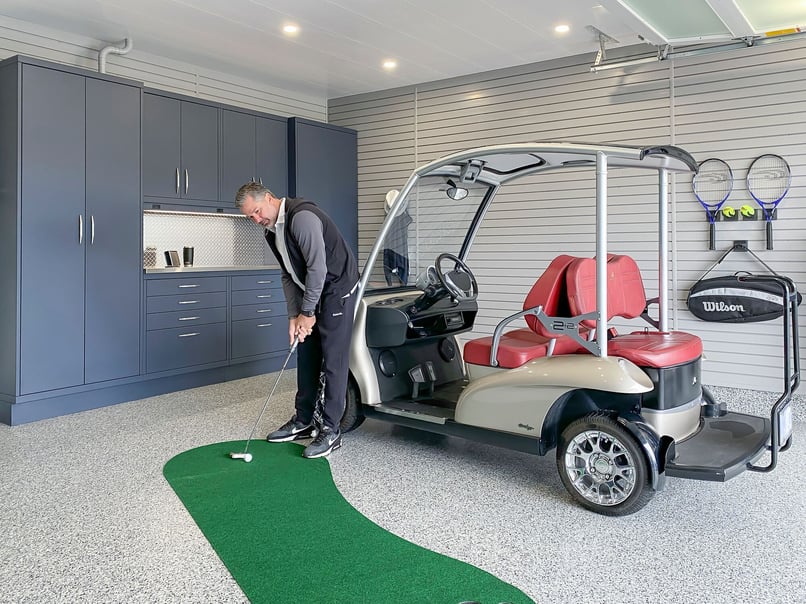 Luxury garage with custom storage, golf gear organization, and premium garage flooring