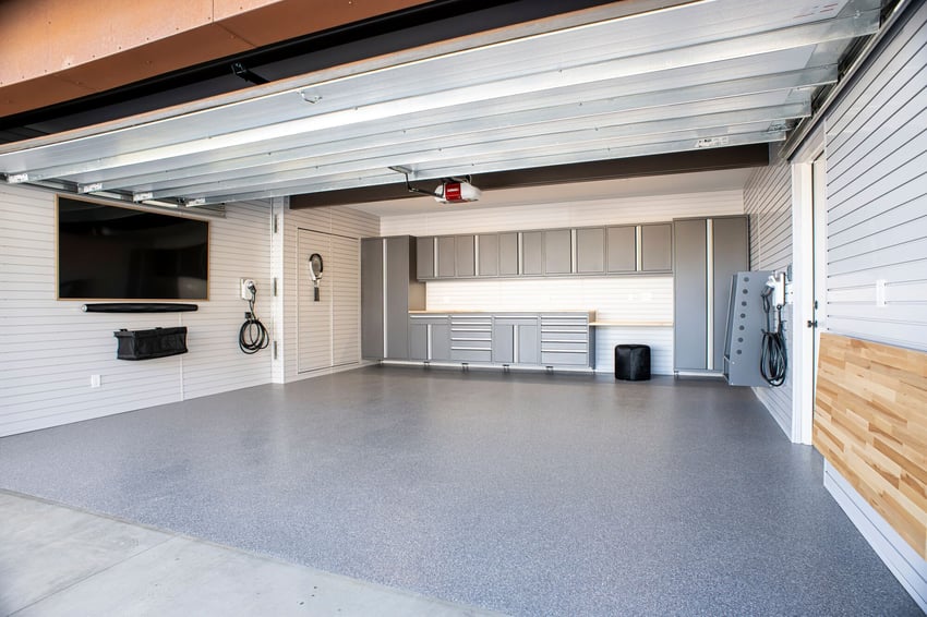 Complete garage transformation with custom storage, cabinetry, wall organizers, and durable garage flooring
