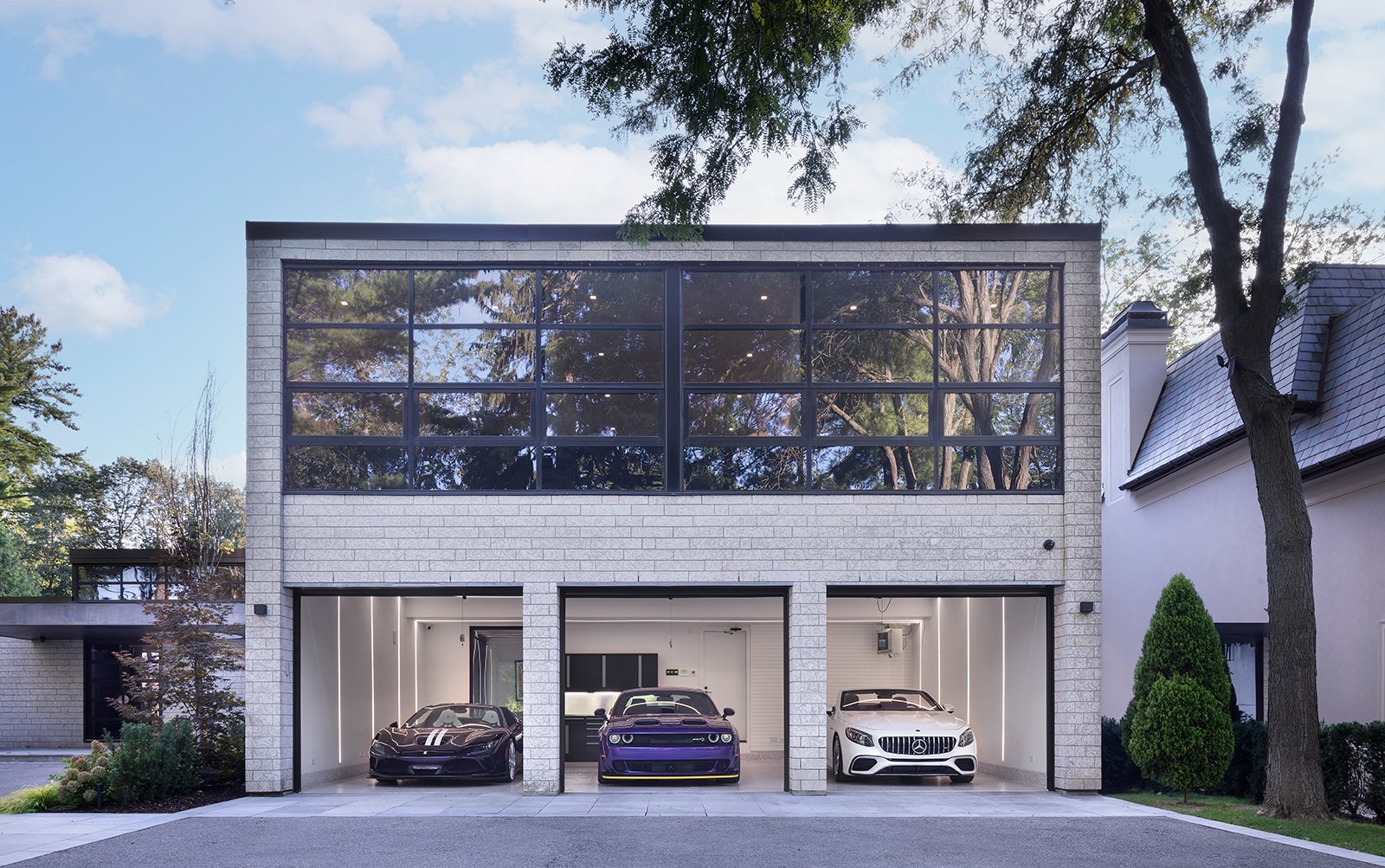 modern home with 3 cars parked in garage