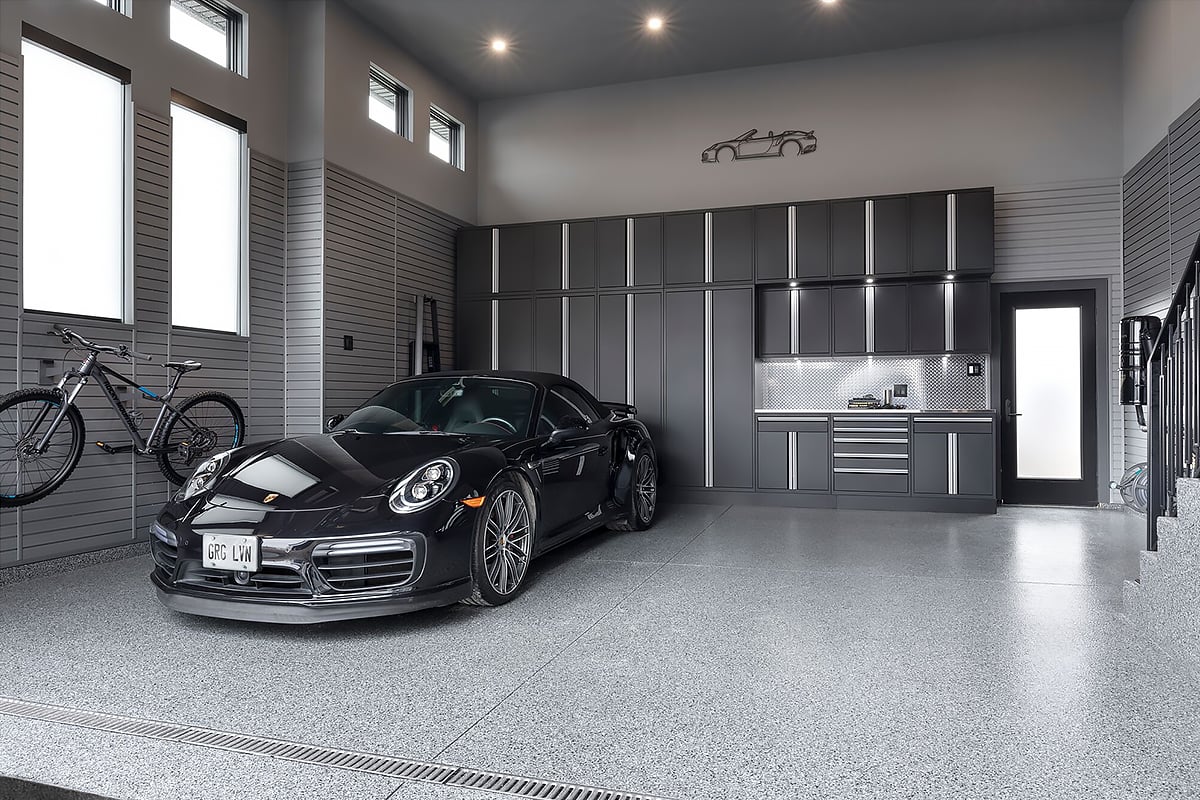 showroom quality garage by Garage Living with black Porsche and grey cabinetry