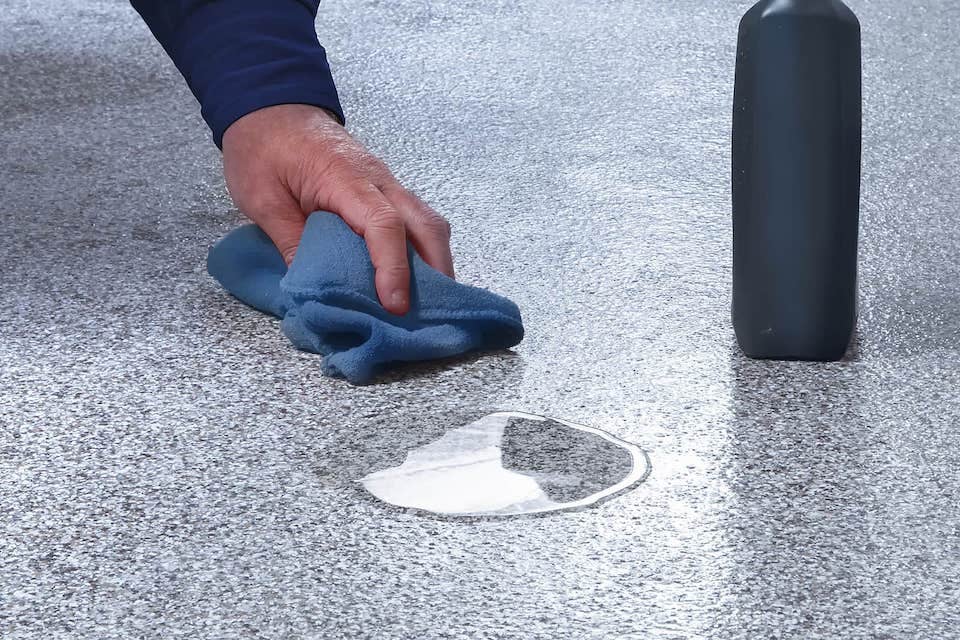 man cleaning spill on floor