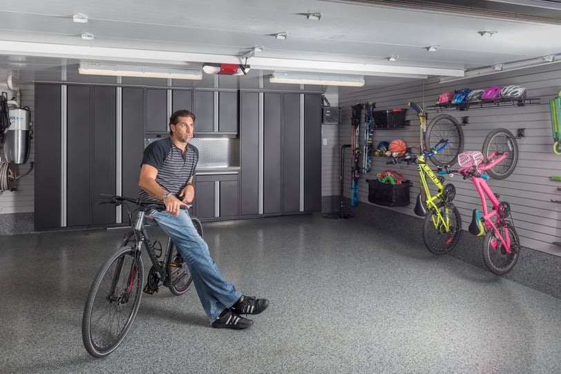 Organized garage with wall-mounted bike storage, slatwall panels, and specialty garage accessories.