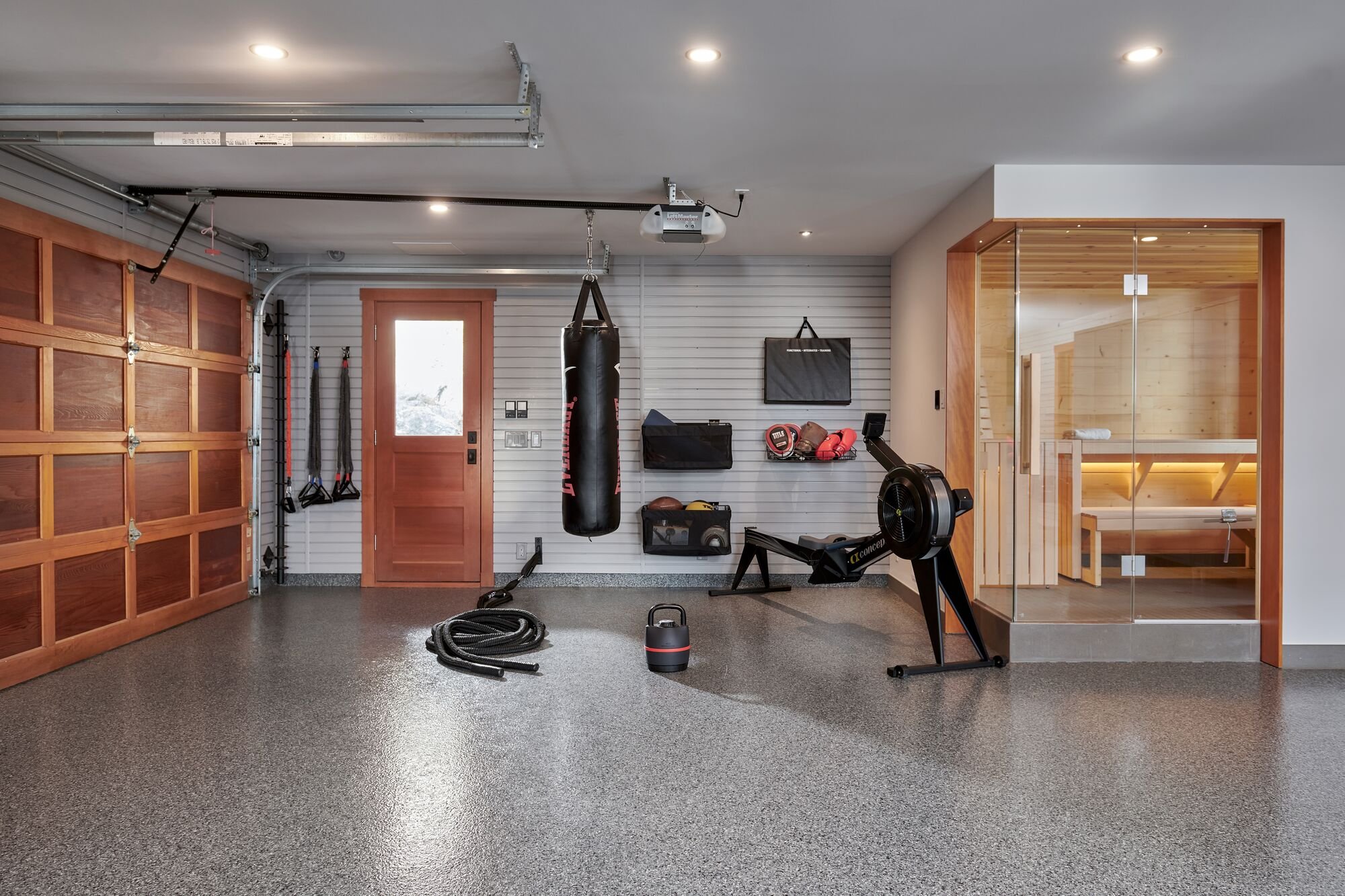 Lifestyle-focused garage renovation featuring a sauna and home gym in a well-designed space