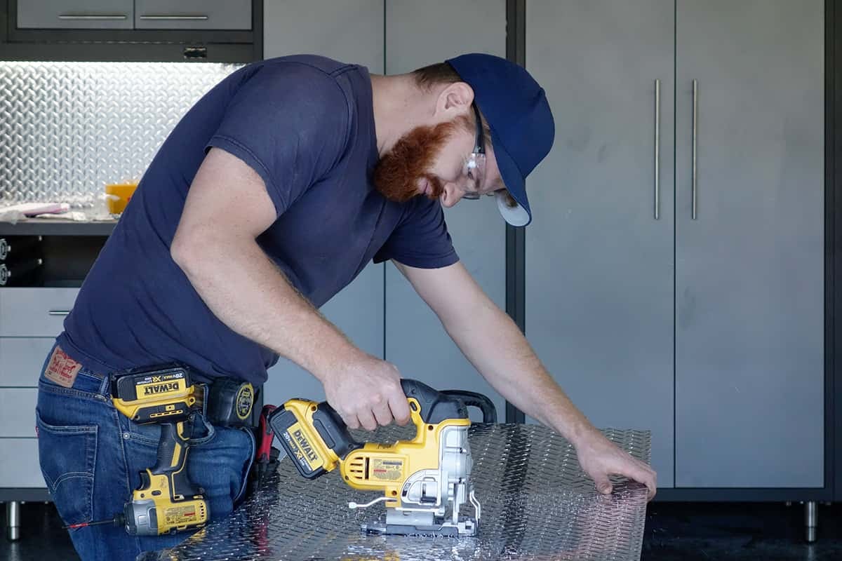 man using power tools in workshop garage