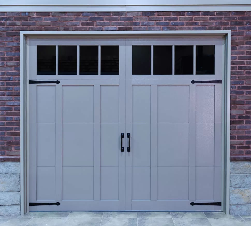 Carriage House Steel overlay garage door with decorative hardware.