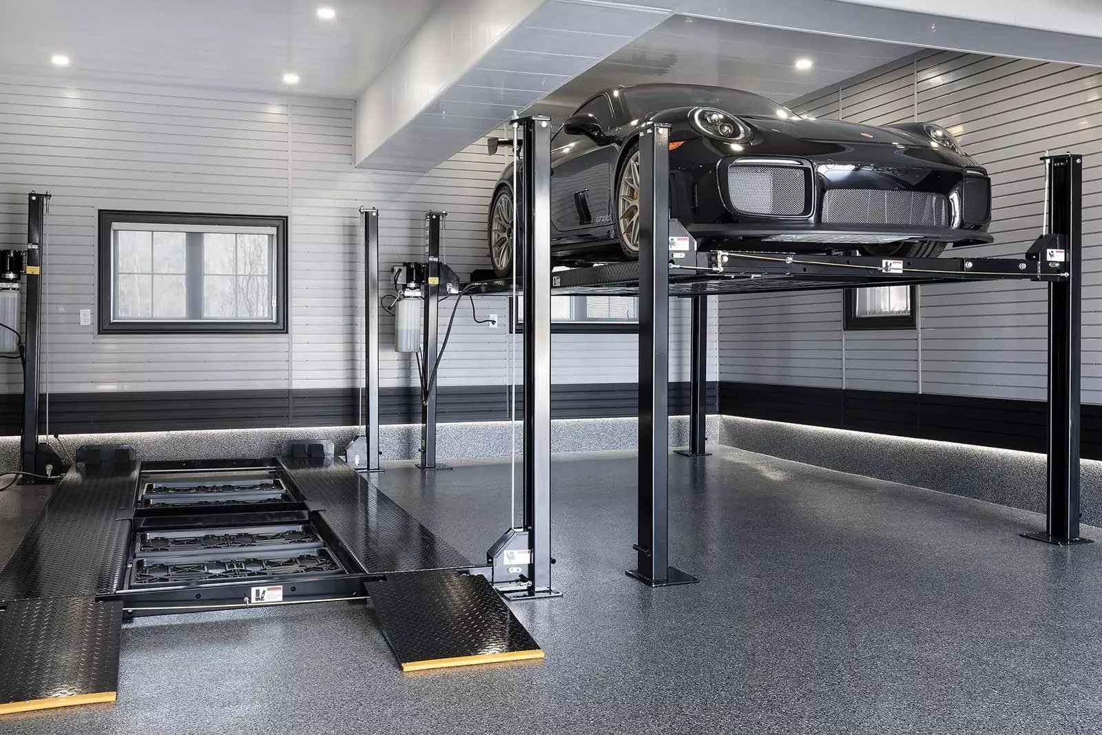 https://www.garageliving.com/hs-fs/hubfs/xdouble-car-lift-garage-10-porsche-elevated.jpg.pagespeed.ic.vaF1gCzReG.webp?width=1600&name=xdouble-car-lift-garage-10-porsche-elevated.jpg.pagespeed.ic.vaF1gCzReG.webp