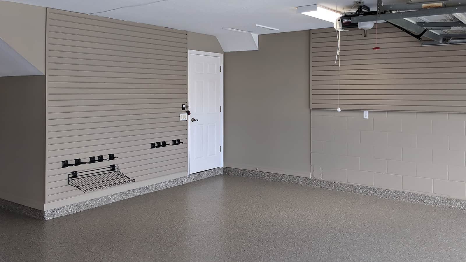 After: Slatwall panels in taupe provide plenty of wall storage and provide a much cleaner look overall.
