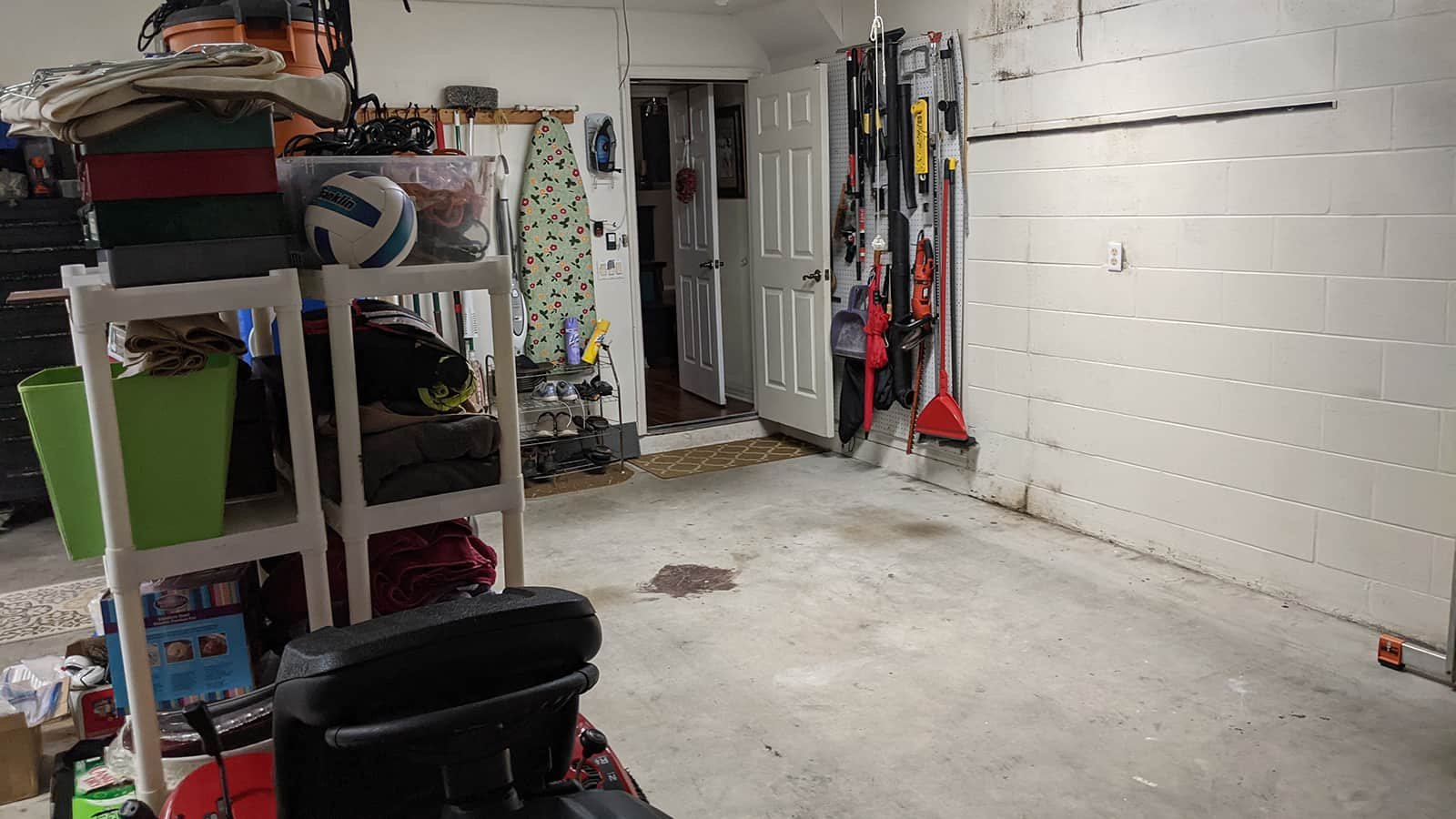Before: unfinished garage floor and inadequate wall storage.