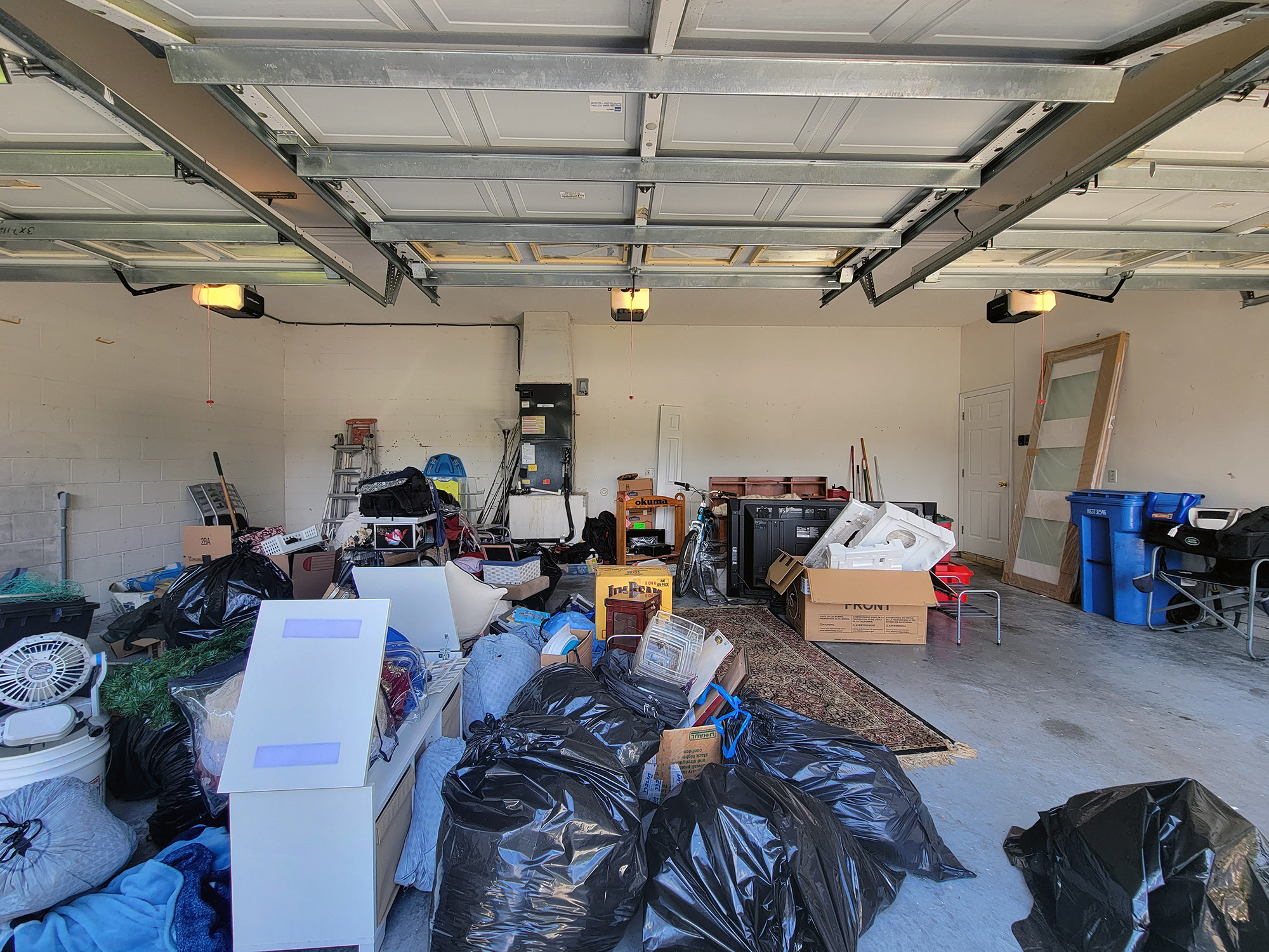 A cluttered garage - New garage project in the works - Garage Living of Tampa Florida