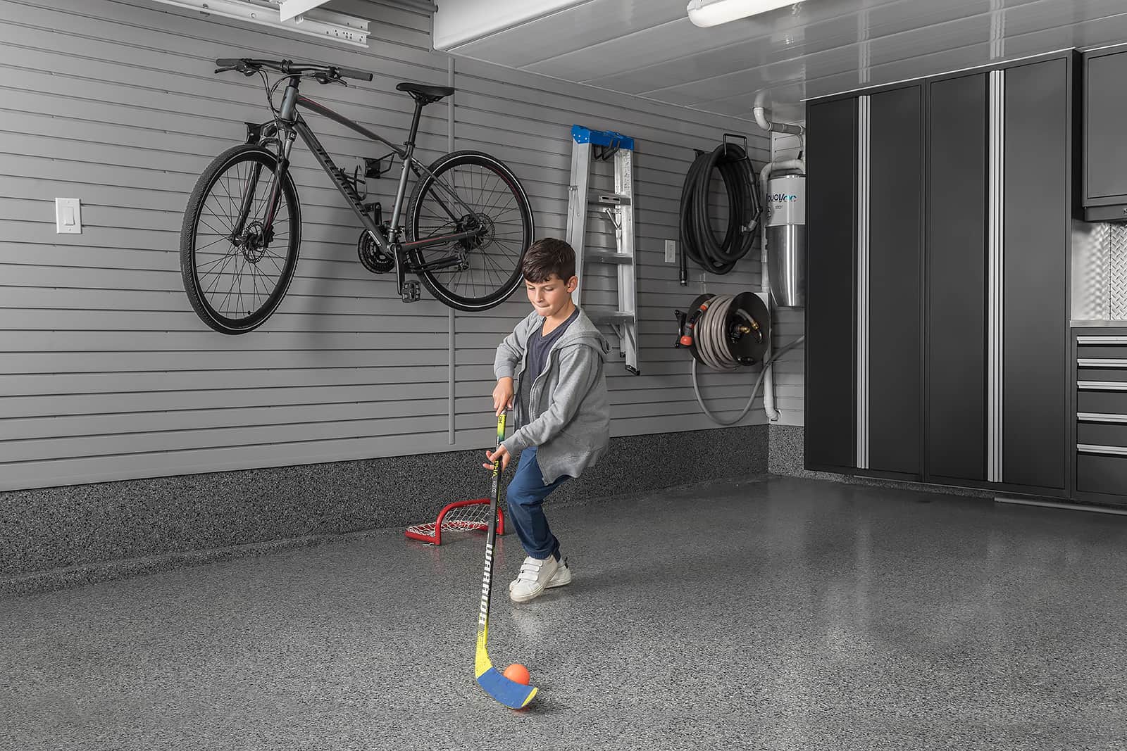 boy-playing-hockey-fitness-room-garage
