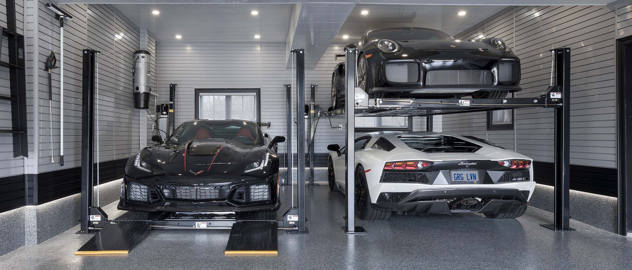 A dual car lift provides quick access to the homeowner’s Corvette ZR1, Lamborghini Aventador, and Porsche GT2 RS.