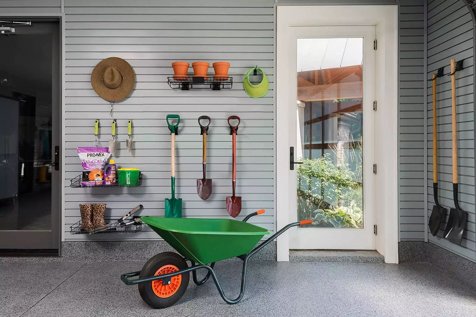 Slatwall storage helps to keep the gardening tools and supplies, organized and easy to find.