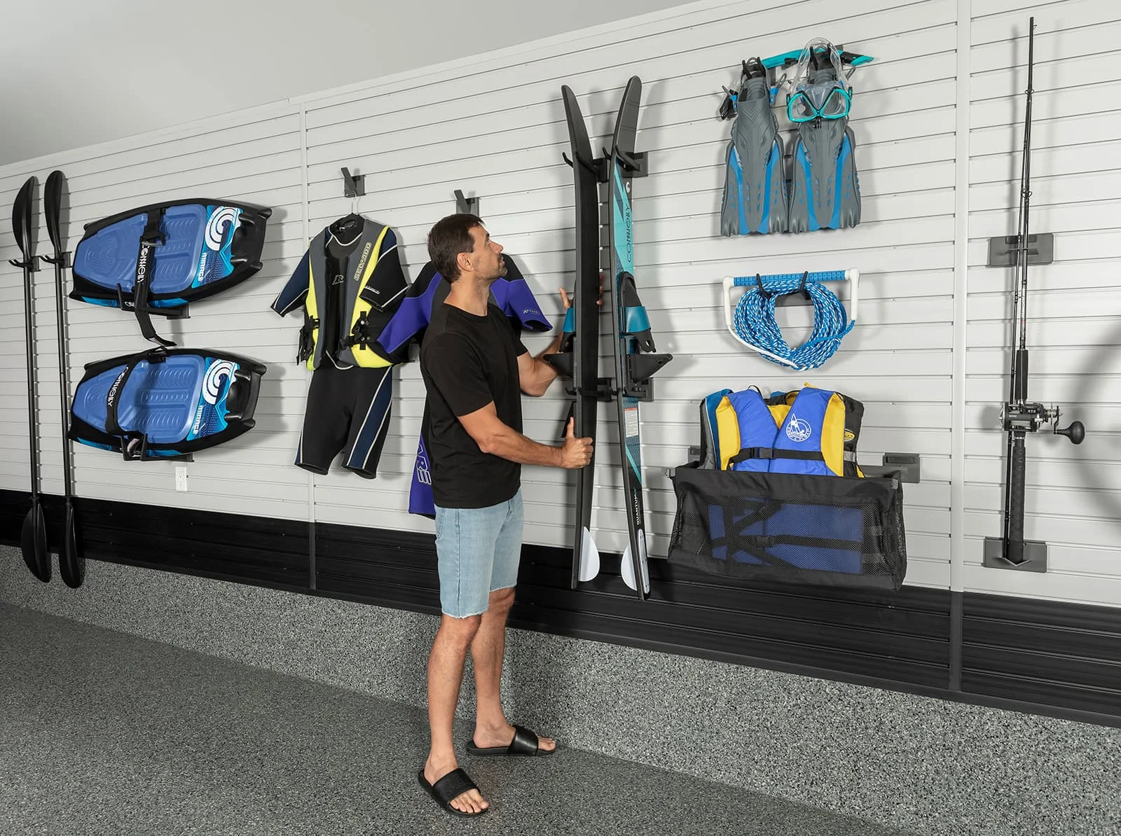 Slatwall garage storage system for organizing water sports equipment - Garage Living